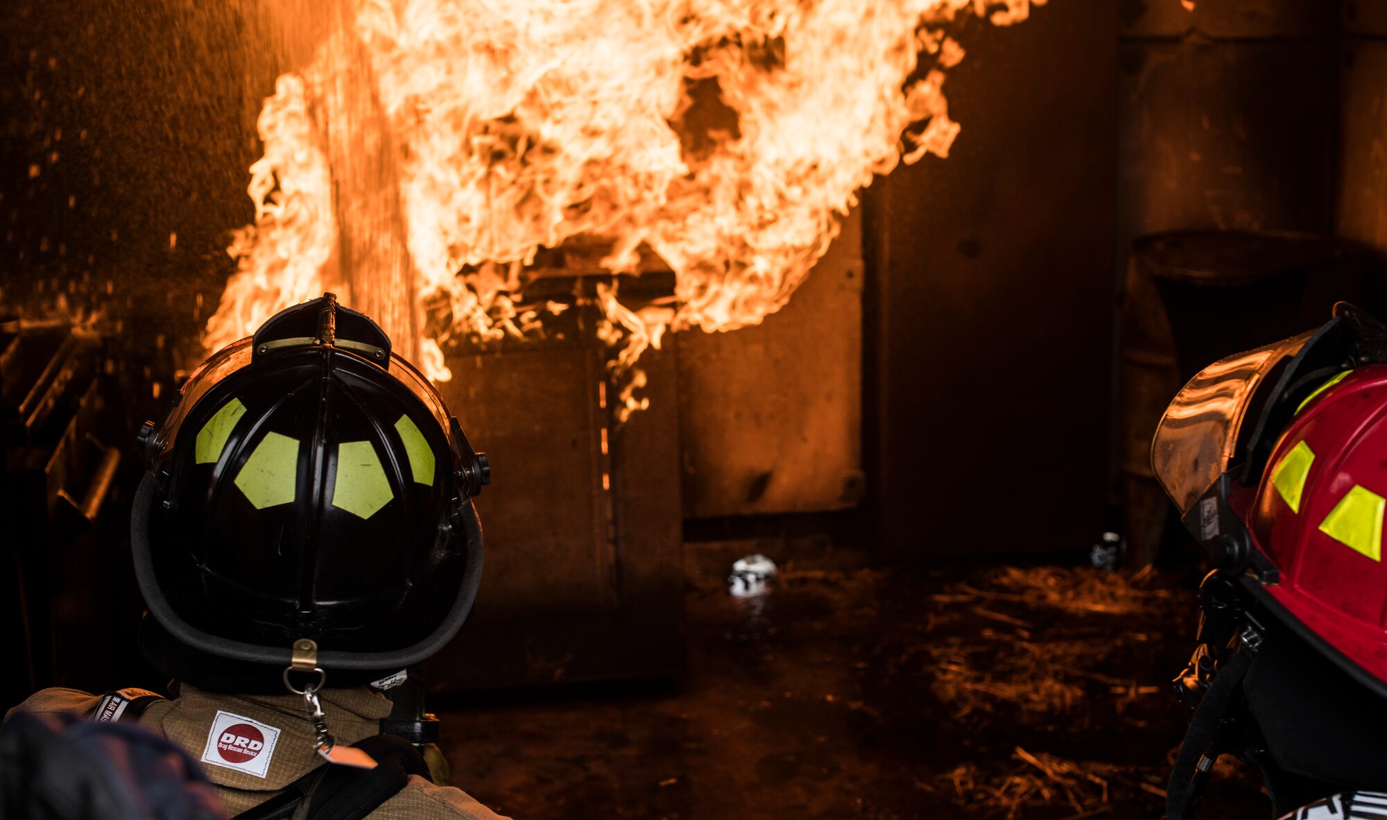 436th Civil Engineer Squadron firefighters extinguish flames in a controlled exercise at the structural burn training facility April 26, 2019, at Dover Air Force Base, Del. The U.S. Air Force requires firefighters to participate in the training at least once a year. (U.S. Air Force photo by Senior Airman Christopher Quail)