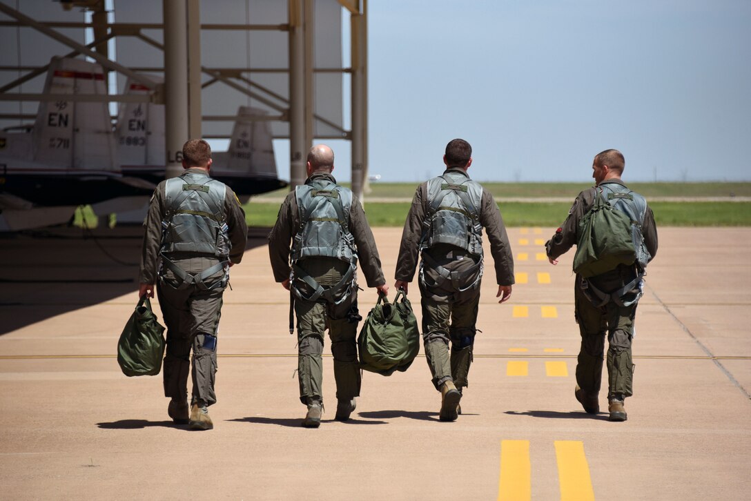 Maj. Gen. Patrick Doherty, 19th Air Force commander, Col. Russell Driggers, 80th Flying Training Wing commander, Lt. Col. Matthew Manning and Maj. Erik Brown, walk towards their T-6 Texan II’s for a familiarization flight, April 26, 2019 at Sheppard Air Force Base, Texas.