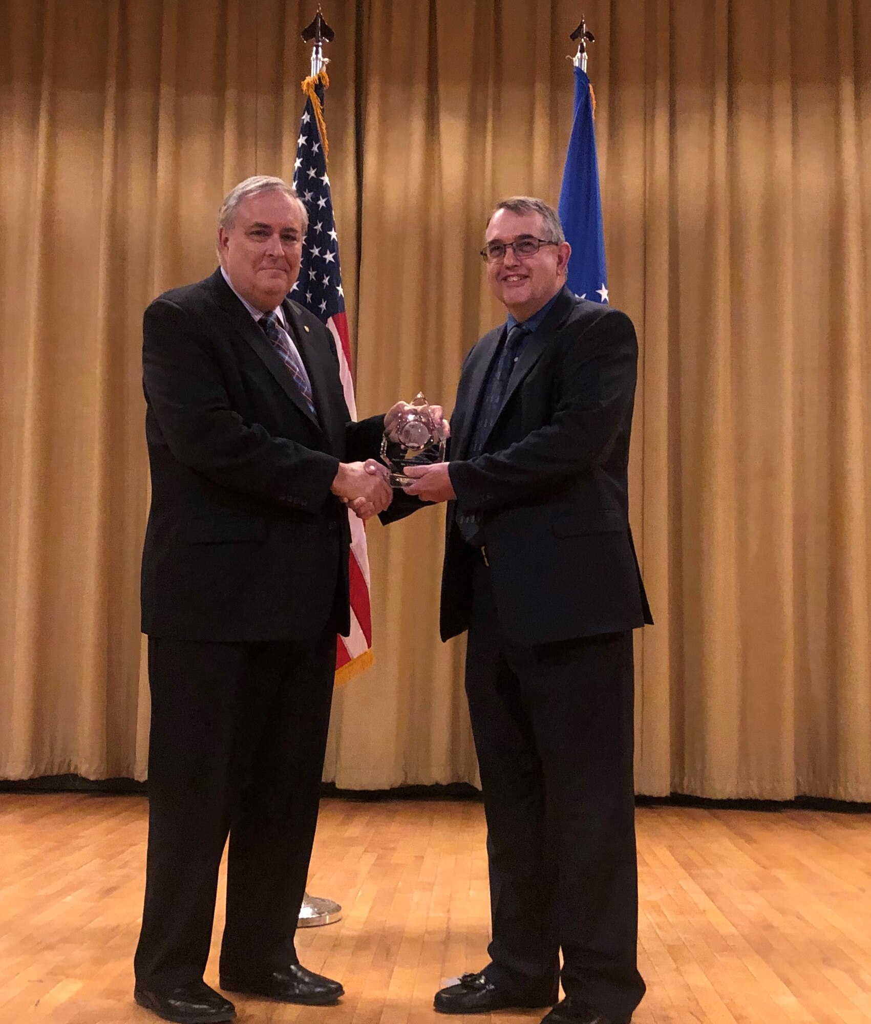 Gary Motsek, Defense deputy assistant secretary for product support, presents Lynn Betts, product support manager for the Ground Based Strategic Deterrent program, with the 2018 Secretary of Defense Product Support Manager Award in the category of Major Defense Acquisition Programs (Acquisition Category I and Other Weapon Systems) on April 11 at Hill AFB, Utah.  The award recognized Betts’ innovative approach to lifecycle and product support management for the $83-billion GBSD program, currently one of the Air Force’s largest acquisition programs.  (Courtesy photo by Tyler Deamer)