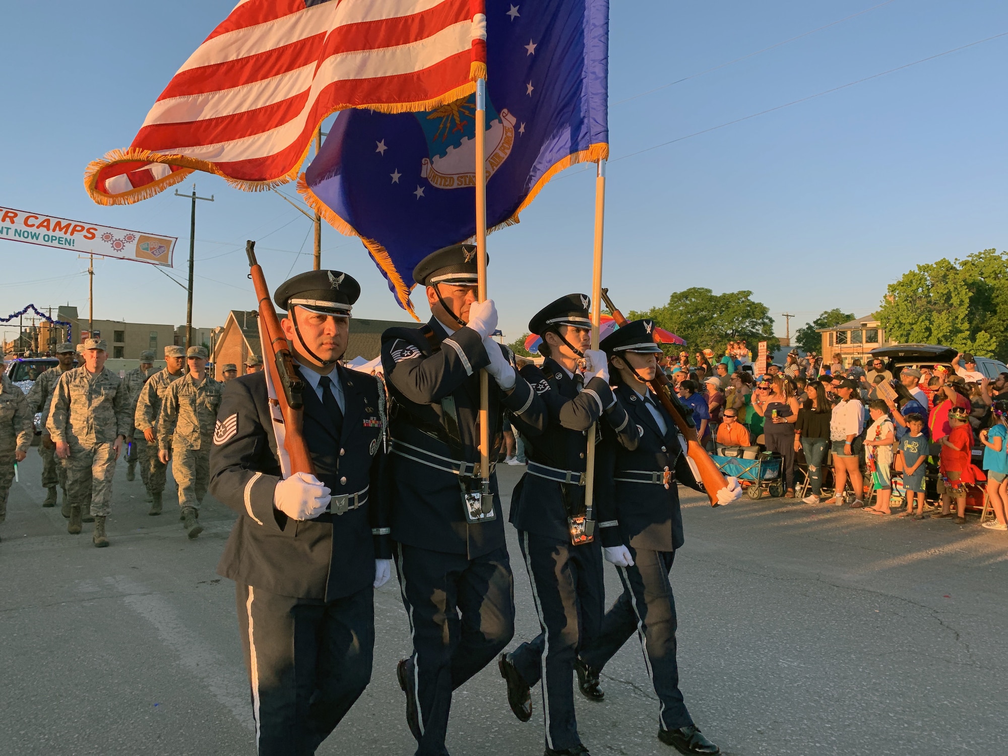 The 433rd Airlift Wing's Honor Guard leads the 433rd Airlift Wing and 960th Cyberspace Wing walkers and float on Dolorosa Street in downtown San Antonio during the 71st annual Fiesta Flambeau Parade, April 27, 2019.