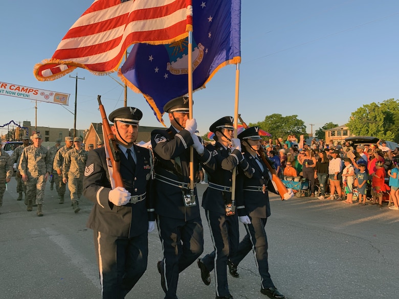 The 433rd Airlift Wing's Honor Guard leads the 433rd Airlift Wing and 960th Cyberspace Wing walkers and float on Dolorosa Street in downtown San Antonio during the 71st annual Fiesta Flambeau Parade, April 27, 2019.