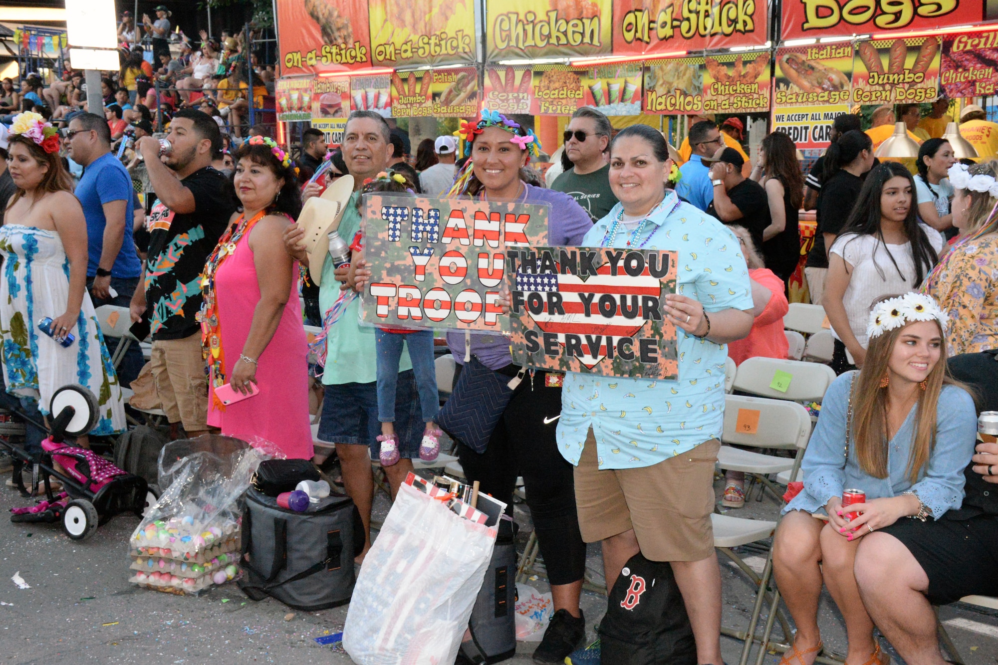 Fiesta Flambeau parade attendees greet the Air Force Reserve Command’s 433rd Airlift Wing and 960th Cyberspace Wing, as they made their way through downtown San Antonio during the Flambeau Parade, April 27, 2019.