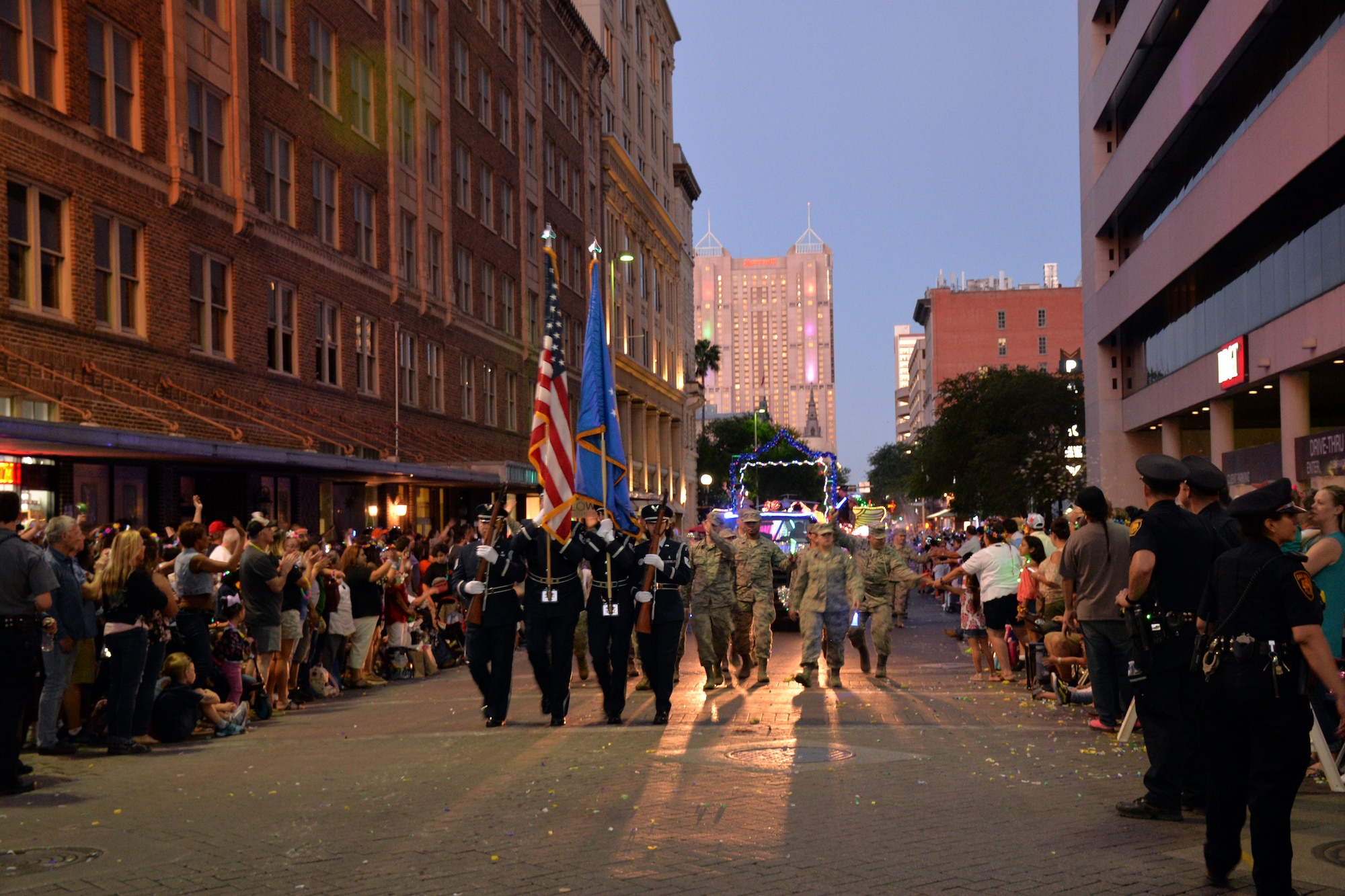 The 433rd Airlift Wing's Honor Guard leads the 433rd Airlift Wing and 960th Cyberspace Wing walkers and float on Commerce Street in downtown San Antonio during the 71st annual Fiesta Flambeau Parade, April 27, 2019.