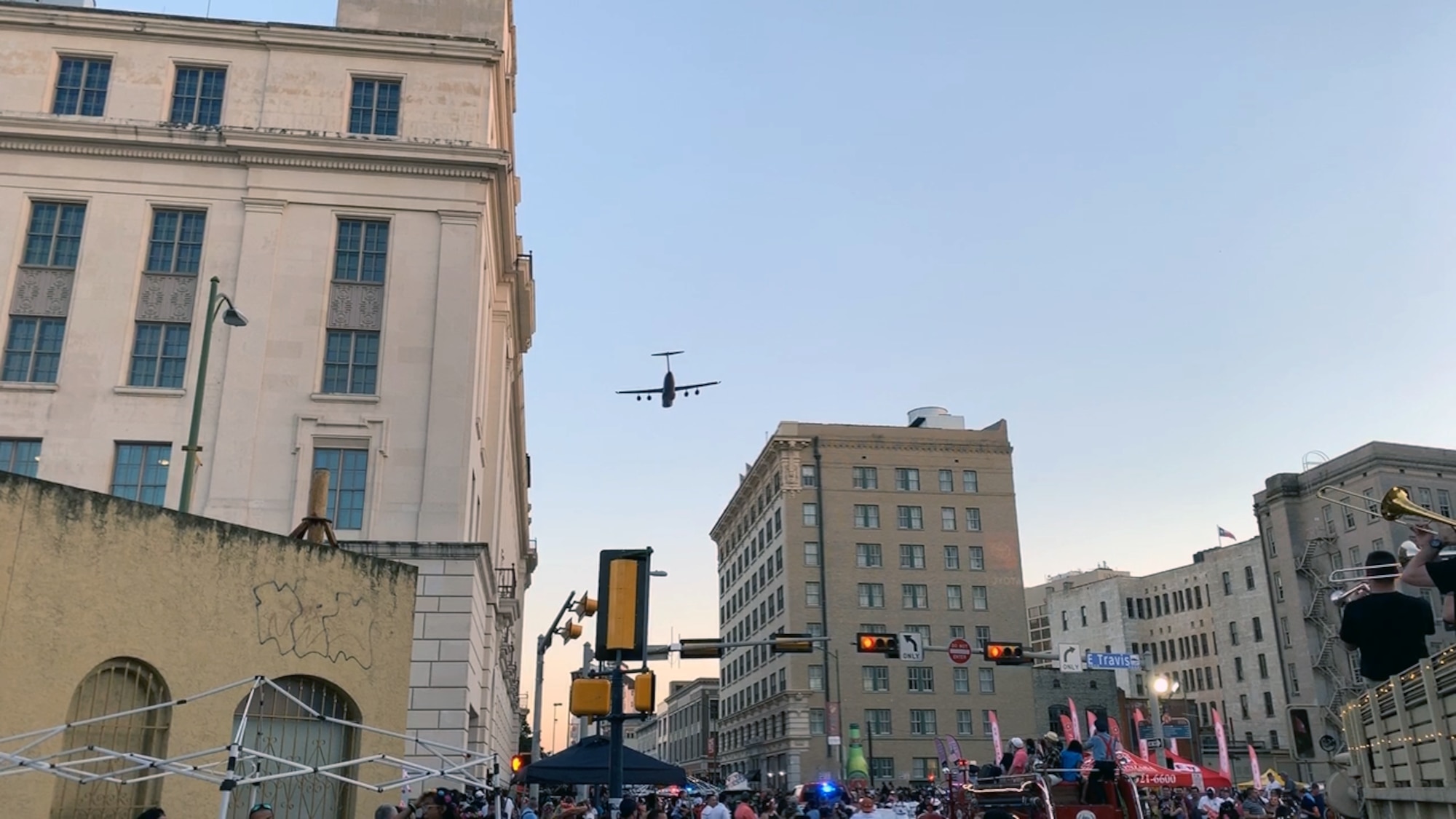 A 433rd Airlift Wing C-5M Super Galaxy flies over the Alamo at an altitude of 1,000 feet as the sun sets in downtown San Antonio as it approaches the Alamo during the 71st annual Fiesta Flambeau Parade, April 27, 2019.