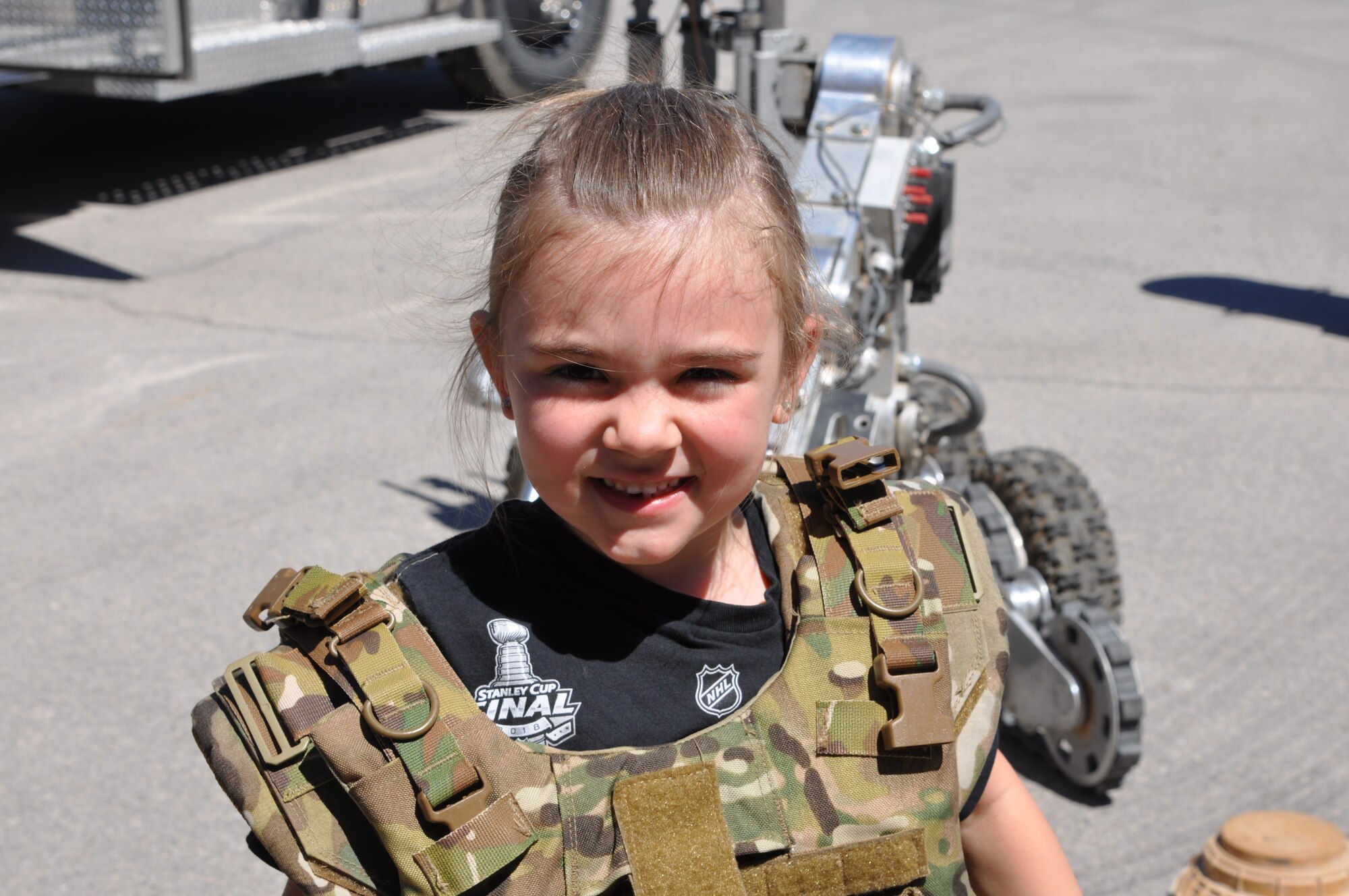 5-year-old Avery dons body armor during a tour of the 926th Wing's Explosive Ordnance Disposal unit April 27 at Nellis Air Force Base, Nev. Her mother, Air Force Staff Sgt. Sabrina Yeghiazarian, the 926th Wing's Development and Training Flight Chief, brought Avery to work on National Take Our Daughters and Sons to Work Day to see firsthand the capability the wing provides. (U.S. Air Force photo by Maj. Candice Allen)