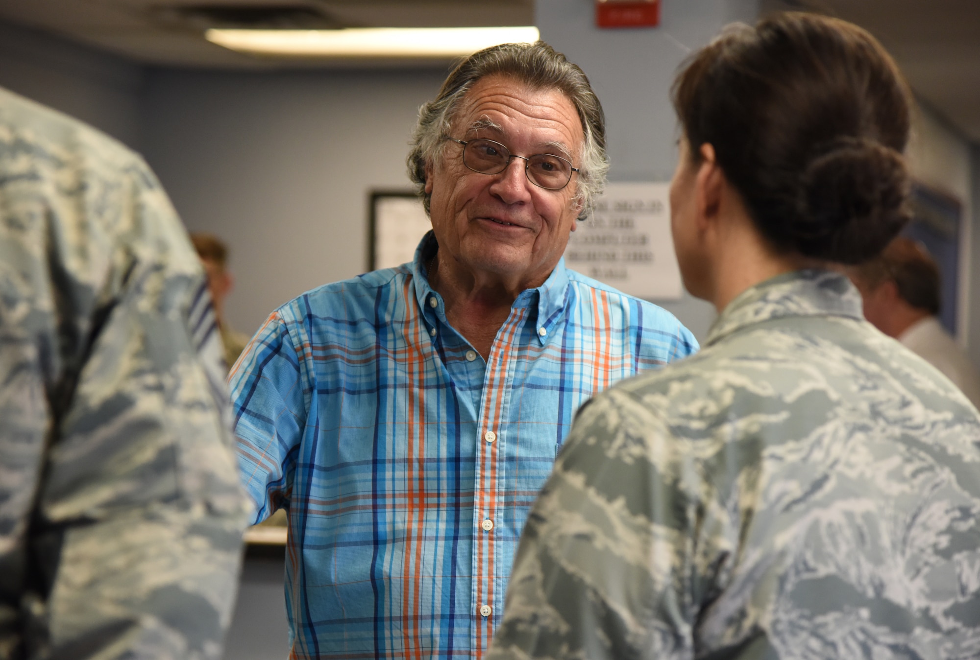 Ashton Belcher, brother of U.S Air Force Maj. Robert Belcher, shares a story about his brother with Col. Debra Lovette, 81st Training Wing commander, and Chief Master Sgt. David Pizzuto, 81st TRW command chief, inside the Visitors Center at Keesler Air Force Base, Mississippi, April 26, 2019. Robert was a F-4 pilot who served during the Vietnam War and was placed in POW/MIA status following his disappearance while on a mission to mark targets in 1969. As a surviving brother of a POW/MIA service member, Ashton is allowed to obtain a Gold Star Family Member ID card for recognition and installation access so that he can attend events and access Airman & Family Readiness Center referral services. (U.S. Air Force photo by Kemberly Groue)