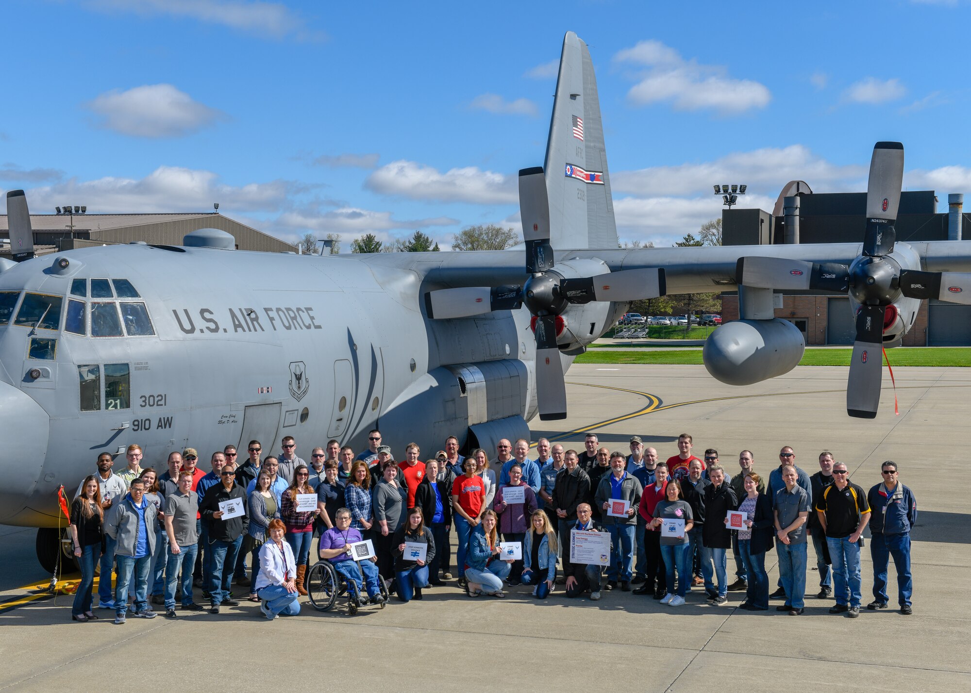 Members of the 910th Airlift Wing pose in front of a C-130H Hercules aircraft here, April 24, 2019, for Denim Day.