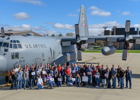 Members of the 910th Airlift Wing pose in front of a C-130H Hercules aircraft here, April 24, 2019, for Denim Day.