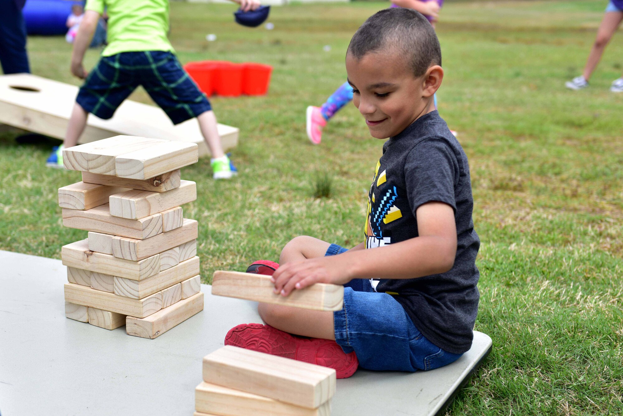 A young boy plays with blocks.