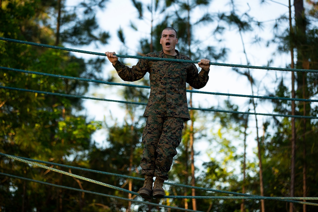 A Marine Corps recruit completes a confidence course.