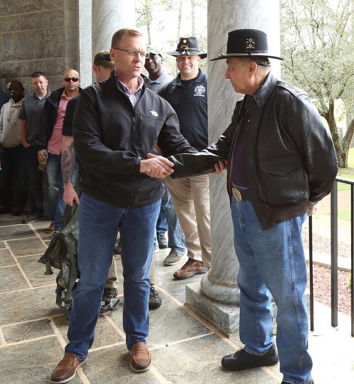 Army Maj. Nick Riviezzo, right, former prisoner of war, receives a coin from Brig. Gen. Joseph F. Shrader, commanding general, Marine Corps Logistics Command, after he discussed his POW experience in Vietnam during a recent tour of the Andersonville National Historic Site in Andersonville, Ga.