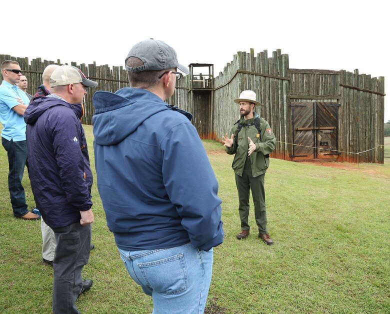 Ryan O'Connell, seasonal park guide, Andersonville National Historic Site, explains to Marines the hardships prisoners of war endured at Camp Sumter, commonly known as the Andersonville Prison, during a recent tour.