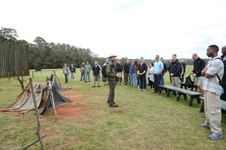 Ryan O'Connell, seasonal park guide, Andersonville National Historic Site, explains to Marines the living conditions prisoners of war endured at Camp Sumter, commonly known as the Andersonville Prison, during a recent tour.