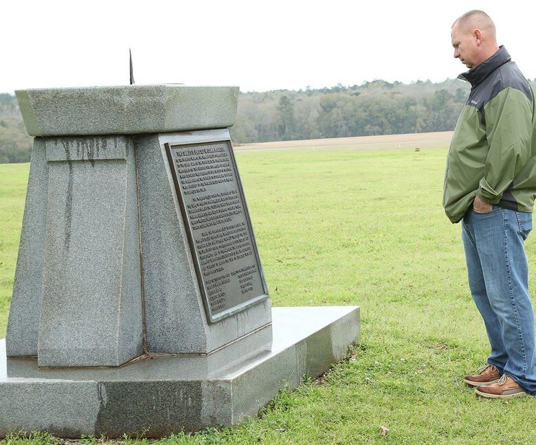A Marine reads a monument plaque during a recent tour of the Andersonville National Historic Site in Andersonville, Ga., recently.