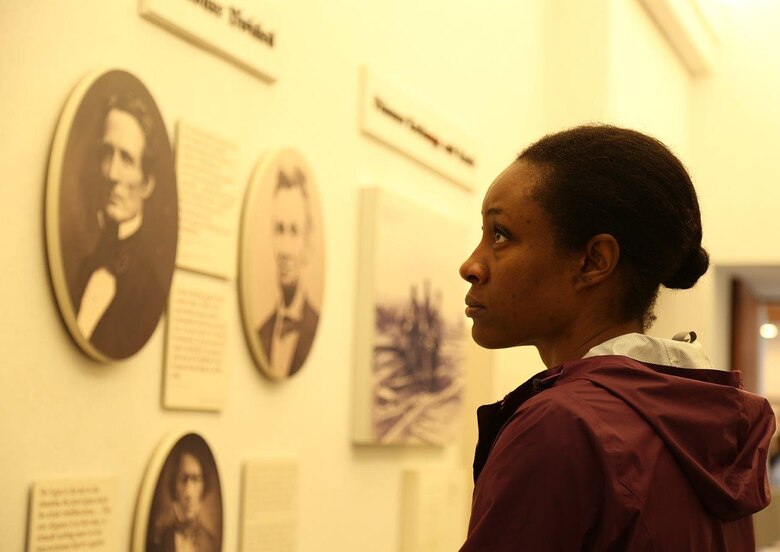 A Marine looks at old photos during a recent tour of the National Prisoner of War Museum in Andersonville, Ga.