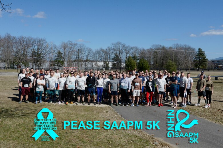 Participants in the Sexual Assault Prevention and Awareness Month 5K pose for photograph before running at Pease Air National Guard Base, N.H. April 6, 2019. The Sexual Assault Prevention and Response Team sponsors the annual event held in April. (U.S. Air National Guard photo by Senior Airman Victoria Nelson)