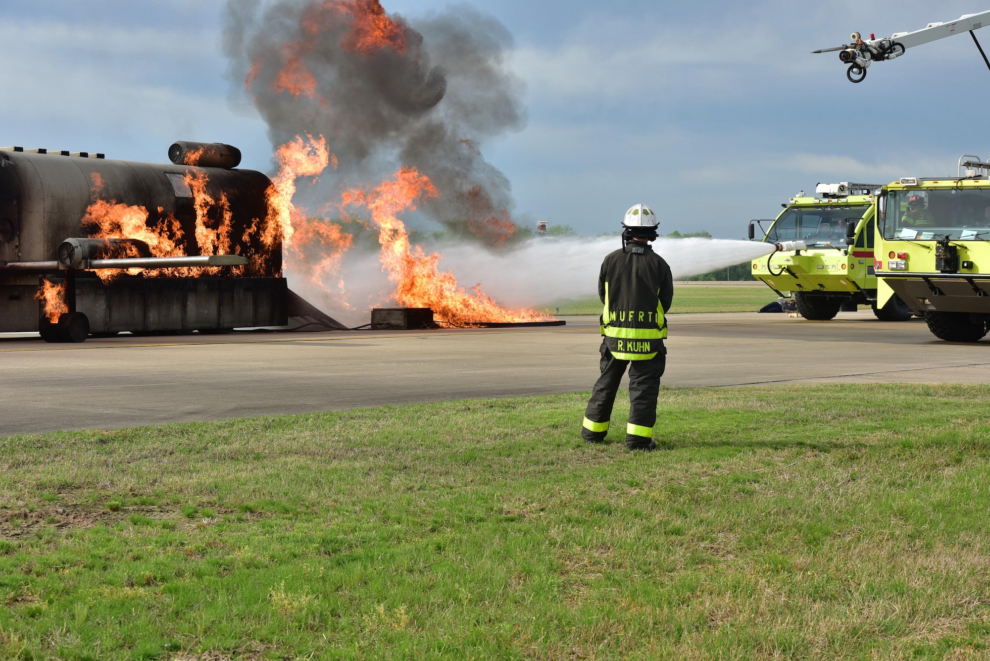 Firemen put out a simulated aircraft fire.