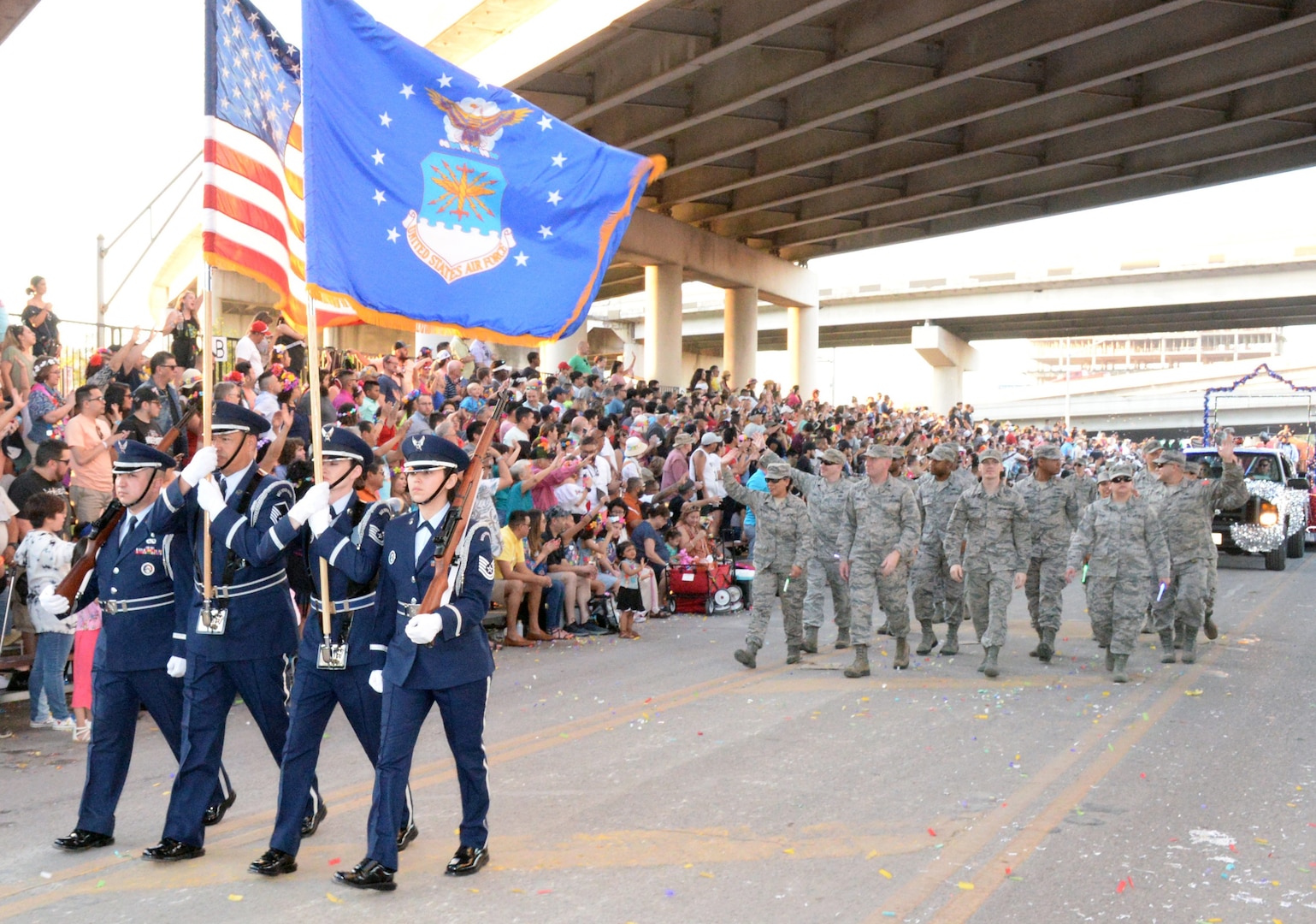 The 433rd Airlift Wing's Honor Guard leads the 433rd Airlift Wing and 960th Cyberspace Wing walkers and float on Broadway Street in downtown San Antonio during the 71st annual Fiesta Flambeau Parade April 27. More than 750,000 spectators lined the 2.6-mile-long route see more than 200 floats and marching bands perform in the grand finale of Fiesta Week.