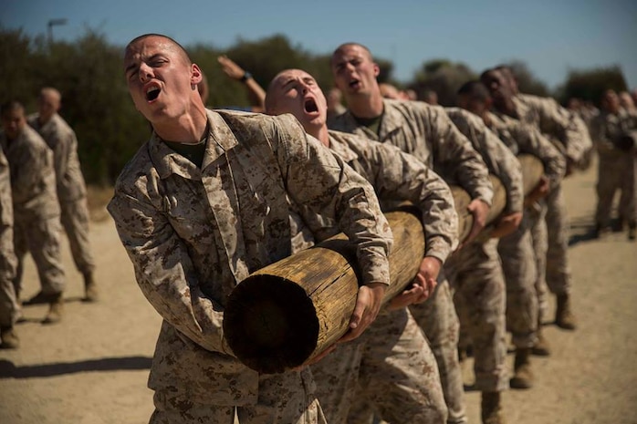 Recruits with Kilo Company, 3rd Recruit Training Battalion, perform side curls with a log at Marine Corps Recruit Depot San Diego, April 22.