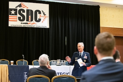 A military general speaks before an audience.