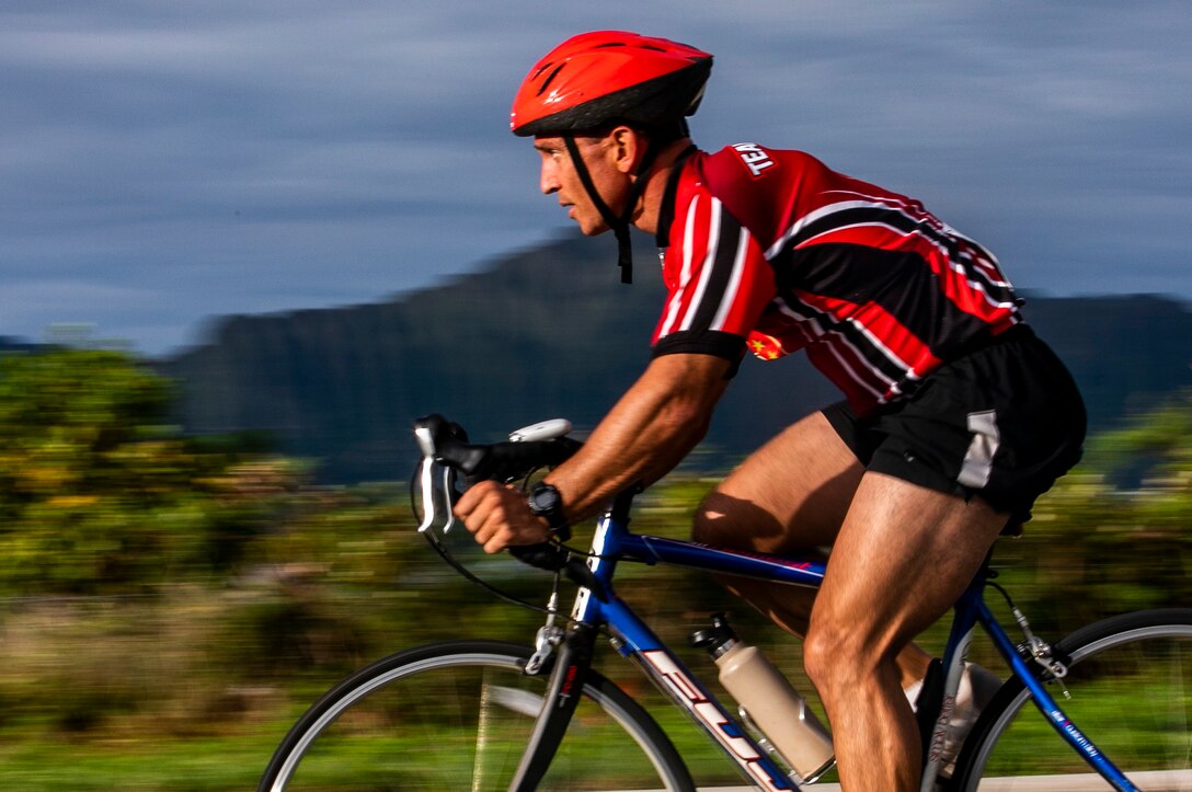 U.S. Navy Lt. Lucas Rex, battalion chaplain, Headquarters Battalion, Marine Corps Base Hawaii (MCBH), conducts the bicycling event of the Koa Kai sprint triathlon race, Marine Corps Air Station Kaneohe Bay, MCBH, Apr. 28, 2019. The swim, bike, run triathlon is an annual event held aboard the base that is open to both service members and the public and is part of the Commanding Officer's Fitness Series composing of 11 races throughout the year. (U.S. Marine Corps photo by Cpl. Luke Kuennen)