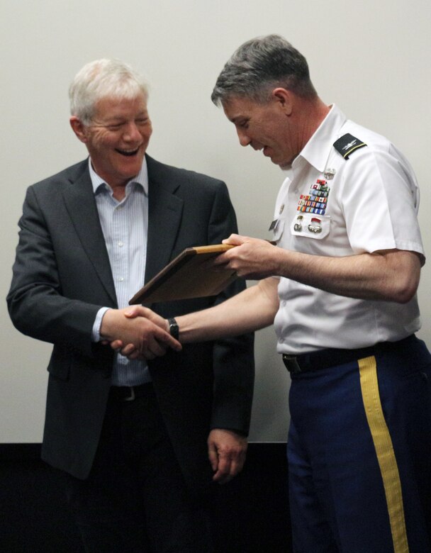 Col. Mark Geraldi presents the U.S. Army Corps of Engineers 2018 Excellence in Partnership award to Discover Your Northwest Executive Director Jim Adams.