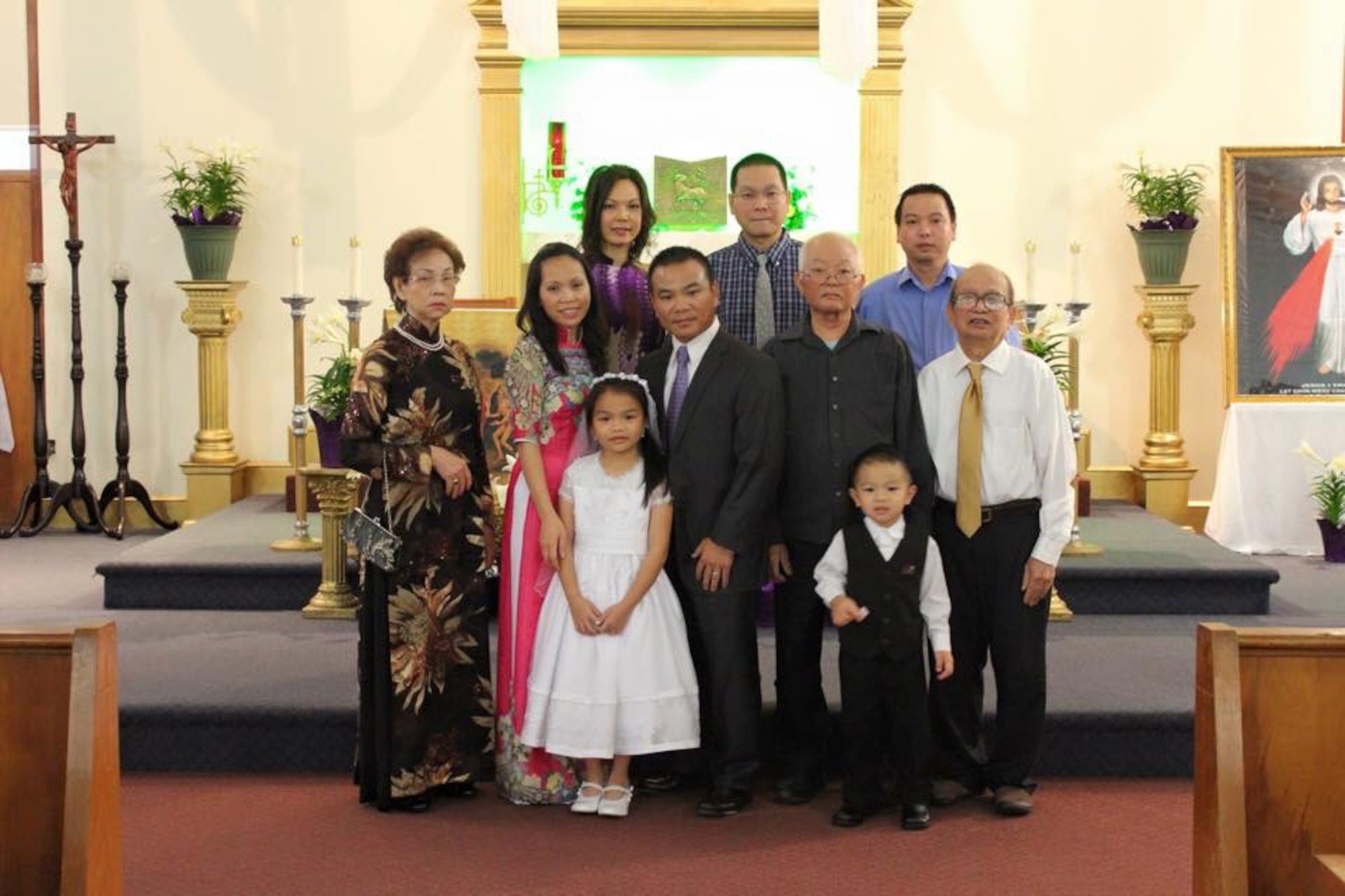 Lt. Col. Asan Bui (center), a flight commander with the 920th Rescue Wing, poses with his family at their local church. Bui, a devout Catholic, said his community and faith provided him with positive outlets growing up, to include piano lessons. The 920th RQW conducts combat-search-and rescue missions at land and sea. (Courtesy photo)