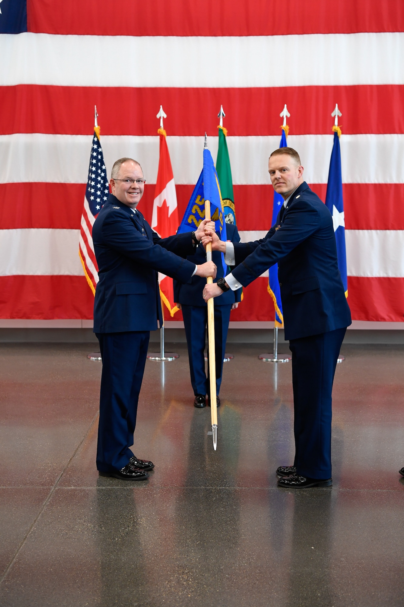 Col. Scott Humphrey presides over the 225th Air Defense Squadron Change of Command ceremony where Col. Brett Bosselmann relinguishes command to Lt. Col. Brian Bergren at the Pierce County Readiness Center, April 10, 2019.