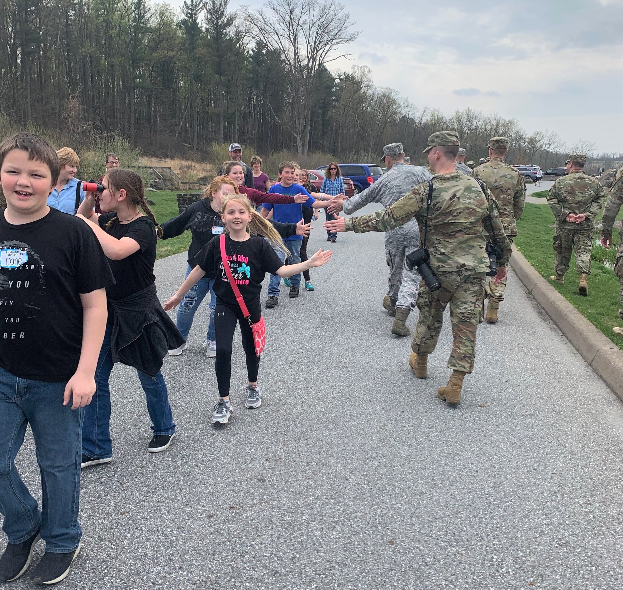A middle school tour group high-fives Air Force District of Washington Airmen during a tour of the Gettysburg Battlefield in Pennsylvania April 18. The service members were there as part of the 2019 AFDW Commander and Spouse Orientation Course. (U.S. Air Force photo by Master Sgt. Amaani Lyle)