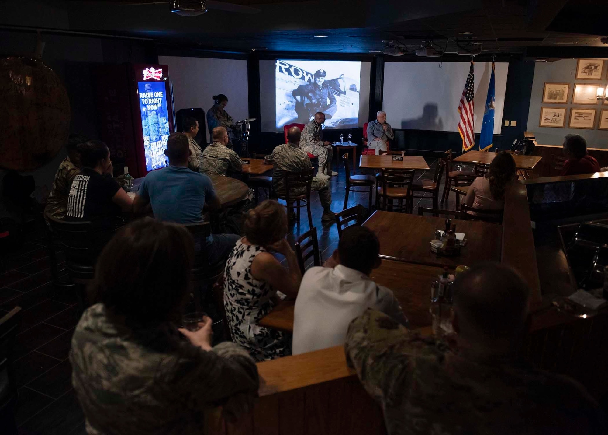 Airmen and civilians listen to an Army Air Corps retiree's speech.