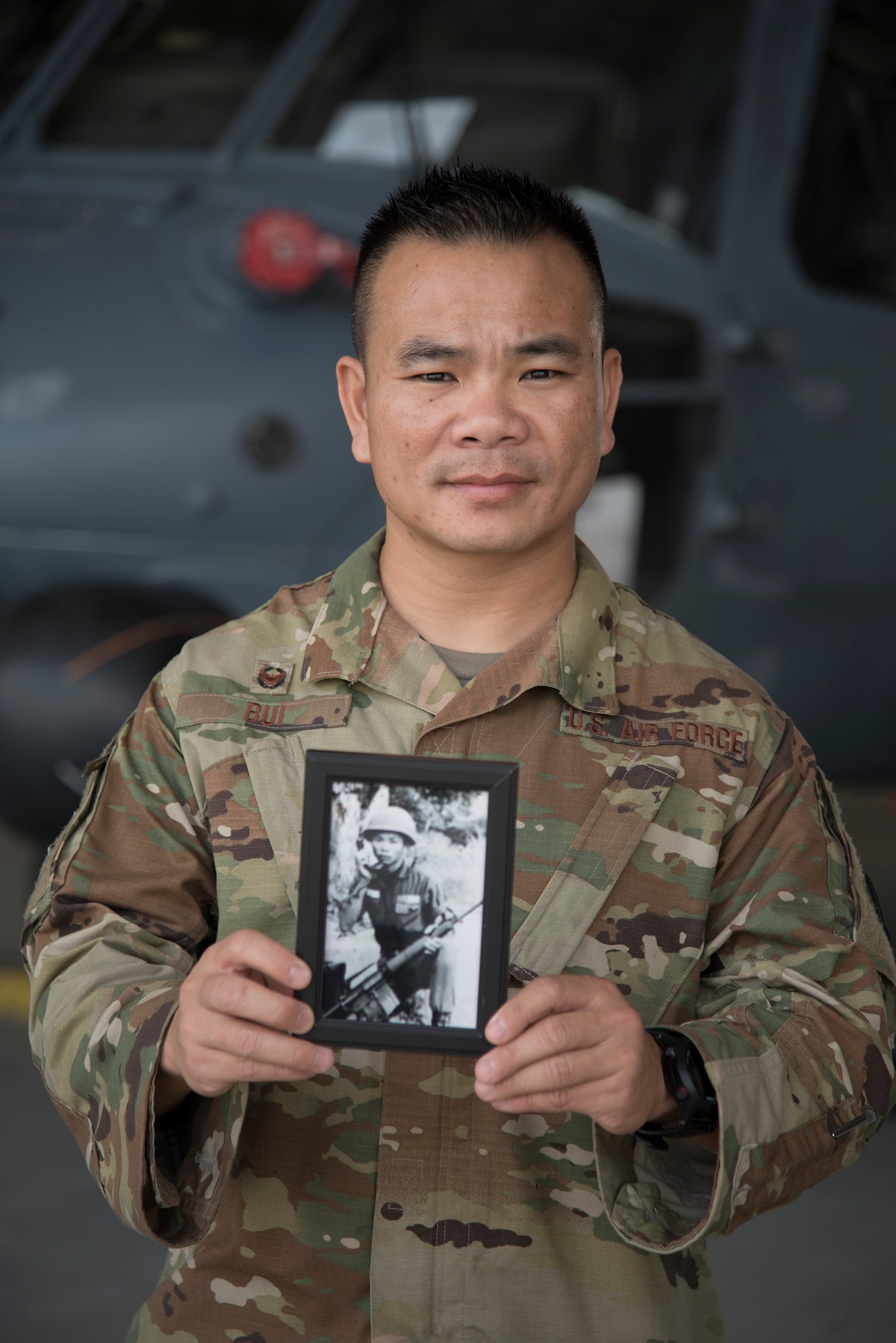 Lt. Col. Asan Bui, 920th Communications Flight commander, holds a photo of his late father, Chien Van Bui, while on duty at Patrick Air Force Base, Florida, on April 6, 2019. Bui said he has a lot of respect for his father who served in the South Vietnamese Army during the Vietnam War. The lieutenant colonel serves with the 920th Rescue Wing, a combat-search-and-rescue unit as part of the Air Force Reserve. (U.S. Air Force photo by Senior Airman Brandon Kalloo Sanes)