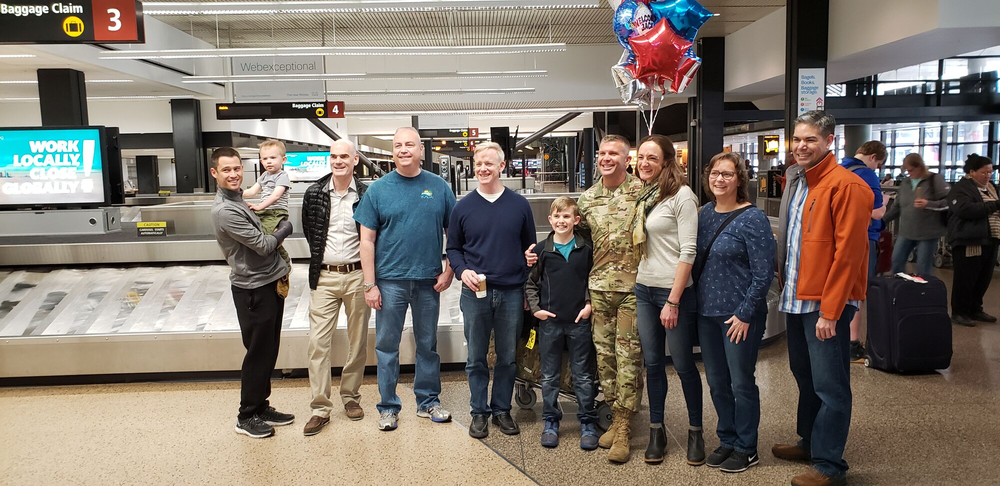 Col. Sean P. Pierce, 446th Airlift Wing commander, is welcomed home at the Seattle International Airport by family and 446th Reserve Citizen Airmen in March. Pierce served as the Mobility Forces director for U.S. Central Command, working for the CEPAC Air Forces Central Command (CFACC) commander in Qatar. (Courtesy Photo)