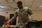 U.S. Air Force Tech. Sgt. John J. Williams, 354th Operations Support Squadron Aircrew Flight Equipment (AFE) flight quality assurance craftsman, packs an F-35A Lightning II survival bag at Eielson Air Force Base, Alaska, April 24, 2019. The AFE Airman’s job is to enhance the probability of survival for downed pilots by supplying all aircraft survival equipment such as parachutes, helmets and survival kits. (U.S. Air Force photo by Airman 1st Class Aaron Larue Guerrisky)