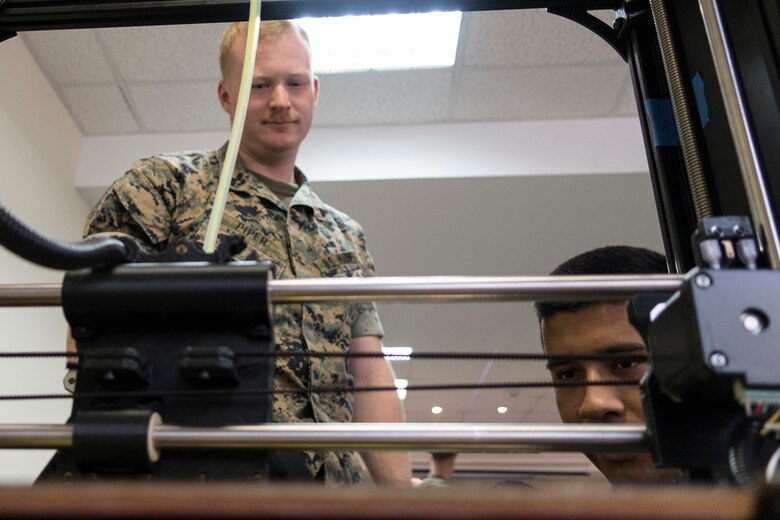 U.S. Marines with Special Purpose Marine Air-Ground Task Force-Crisis Response-Africa observe a 3D printer during an Additive Manufacturing course at Morón Air Base, Spain, June 27, 2018. Marine Corps Systems Command’s Advanced Manufacturing Operations Cell will display additive manufacturing capabilities during the 54th annual Sea-Air-Space Exposition, held May 6–8 at the Gaylord Convention Center in National Harbor, Maryland. (U.S. photo by (U.S. Marine Corps photo by Staff Sgt. Britni M. Garcia Green)