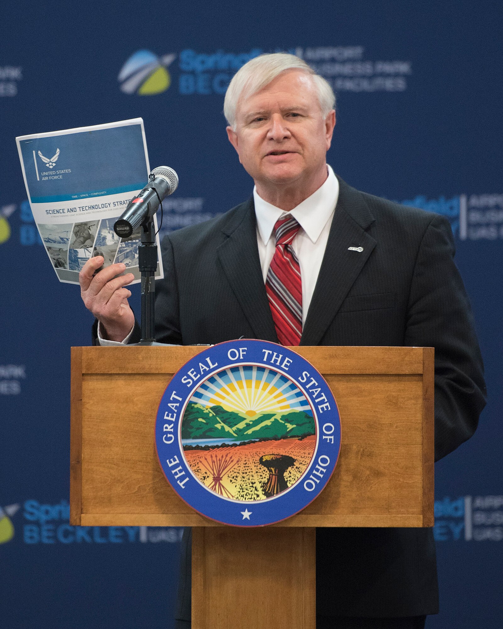 Jack Blackhurst, Air Force Research Laboratory executive director, holds up a copy of the U.S. Air Force Science and Technology Strategy, released by Secretary of the Air Force Heather Wilson, as he addresses the audience April 26, 2019, at the Springfield-Beckley Municipal Airport in Springfield, Ohio. The event was to announce the Federal Aviation Administration granting a Certificate of Waiver or Authorization to AFRL for beyond visual line of sight flights of unmanned aerial systems. (U.S. Air Force photo by R.J. Oriez)