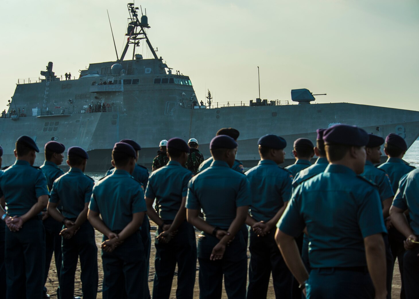 SURABAYA, Indonesia (July 31, 2019) Indonesian Navy (TNI-AL) sailors watch as the Independence-variant littoral combat ship USS Montgomery (LCS 8) arrives in the port of Tanjung Perak as part of Cooperation Afloat Readiness and Training (CARAT) Indonesia 2019. CARAT, the U.S. Navy's longest running regional exercise in South and Southeast Asia, strengthens partnerships between regional navies and enhances maritime security cooperation throughout the Indo-Pacific.