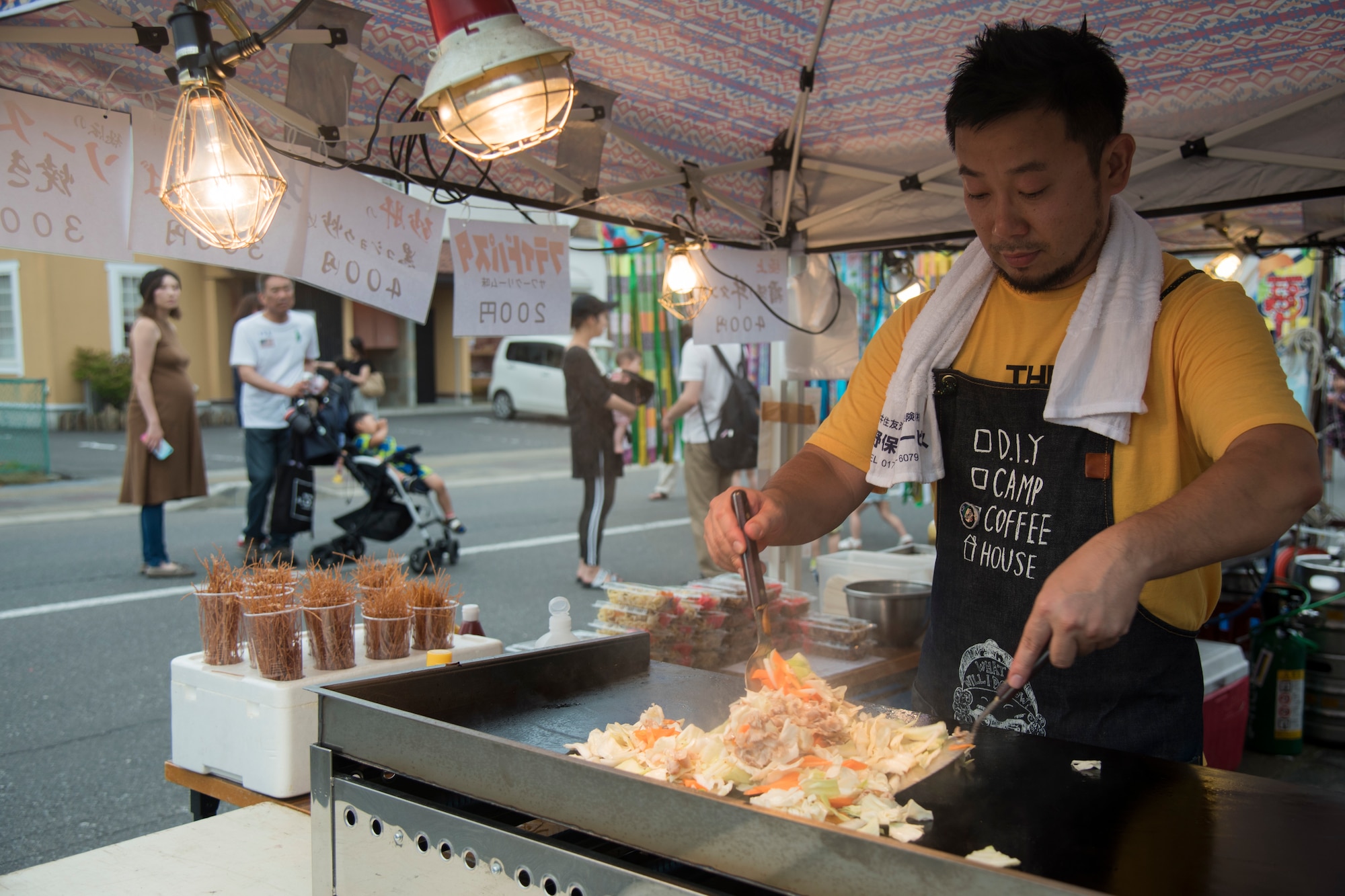 Tsukuda Kazuhito, a food vendor cook, prepares yakisoba noodles during the Tanabata Festival in Misawa City, Japan, July 26, 2019. The festival offered traditional Japanese food items such as octopus balls called, “takoyori,” meat on a stick called, “yakitori” and fried chicken called, “kara-age.” (U.S. Air Force photo by Branden Yamada)