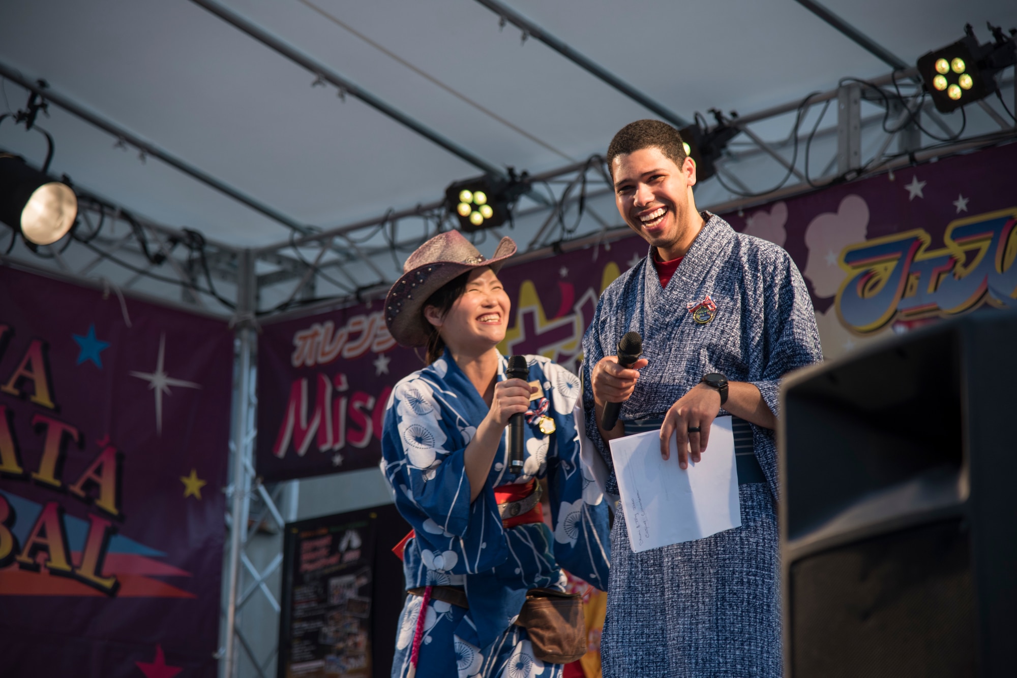 Shumi Kaufman, left, a 35th Force Support Squadron Airman and Family Readiness Center intercultural coordinator, and U.S. Air Force Staff Sgt. Tony Rodeback, an Armed Forces Network – Misawa producer, introduce contestants of the yukata fashion show during the Tanabata Festival in Misawa City, Japan, July 26, 2019. The fashion show featured a variety of guests wearing colorful and traditional Japanese summer kimonos. (U.S. Air Force photo by Branden Yamada)