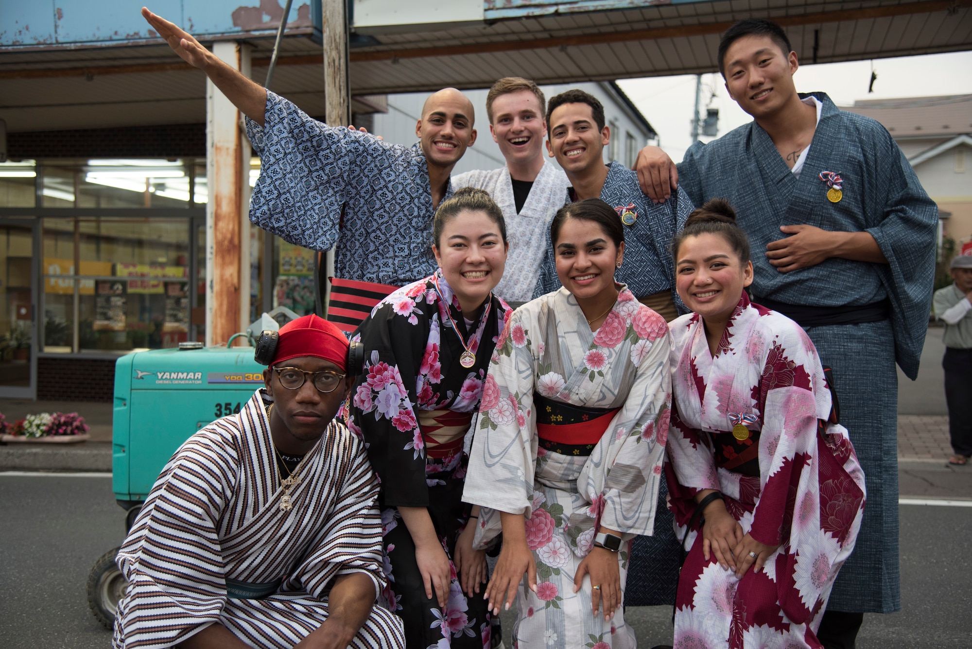 A group of U.S. service members pose in traditional Japanese kimonos during the Tanabata Festival in Misawa City, Japan, July 26, 2019. This wide sleeve loose robe is typically worn as a formal garment for special occasions. Attendees participated in a Yukata fashion contest displaying the garment for judges and audience members to observe and enjoy. (U.S. Air Force photo by Branden Yamada)