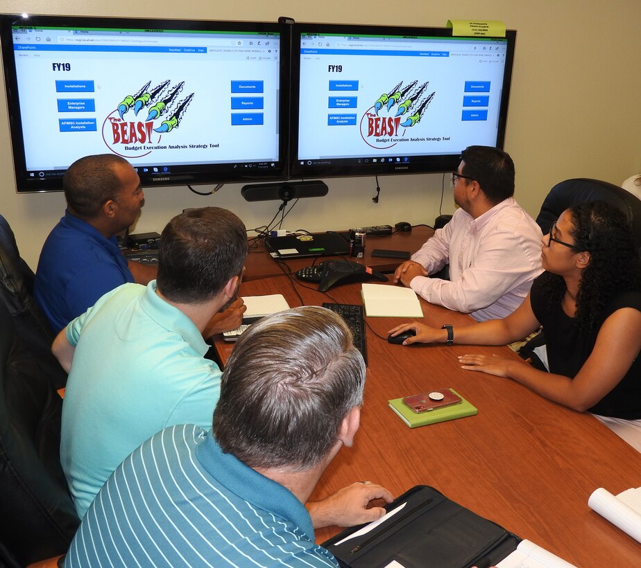 Members of AFIMSC's Budget Office Installation Support Team review the Budget Execution Analysis Strategy Tool (BEAST), to monitor the status of must pay and unfunded requirements at installations across the Air Force. (U.S. Air Force photo by Ed Shannon)