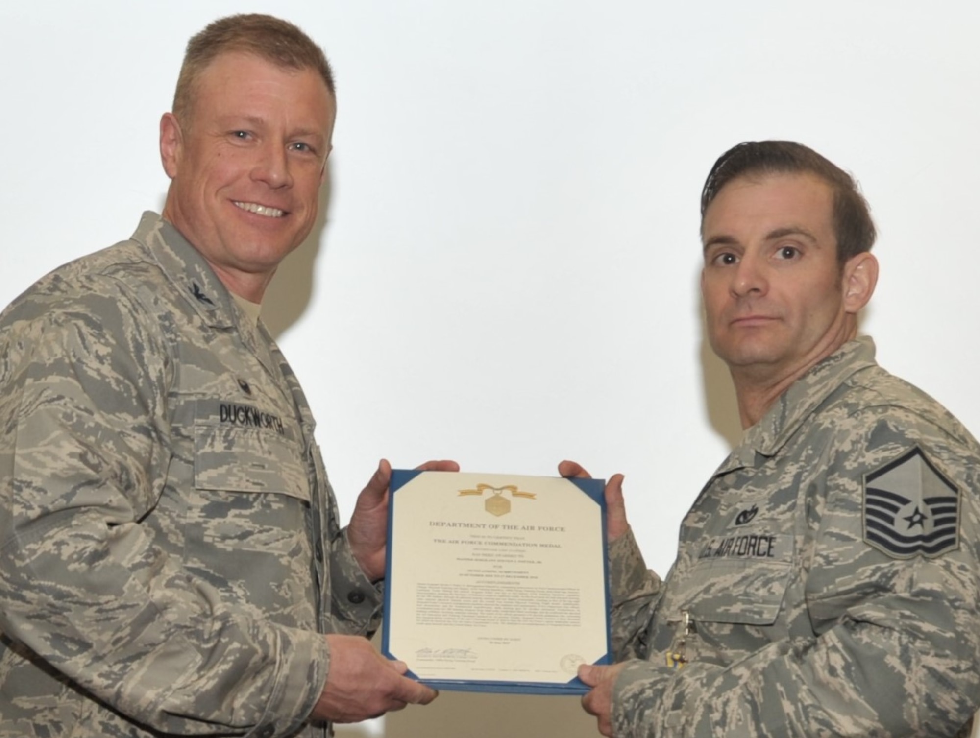 Master Sgt. Steven Potter, Reserve military training instructor assigned to the 433rd Training Squadron, Joint Base San Antonio-Lackland, Texas, accepts the citation to accompany the award of the Air Force Commendation Medal, presented by 340th Flying Training Group Commander Col. Allen Duckworth during the 433rd’s unit training assembly and enlisted summit held at JBSA-Lackland July 23-25. (U.S. Air Force photo by Debbie Gildea)
