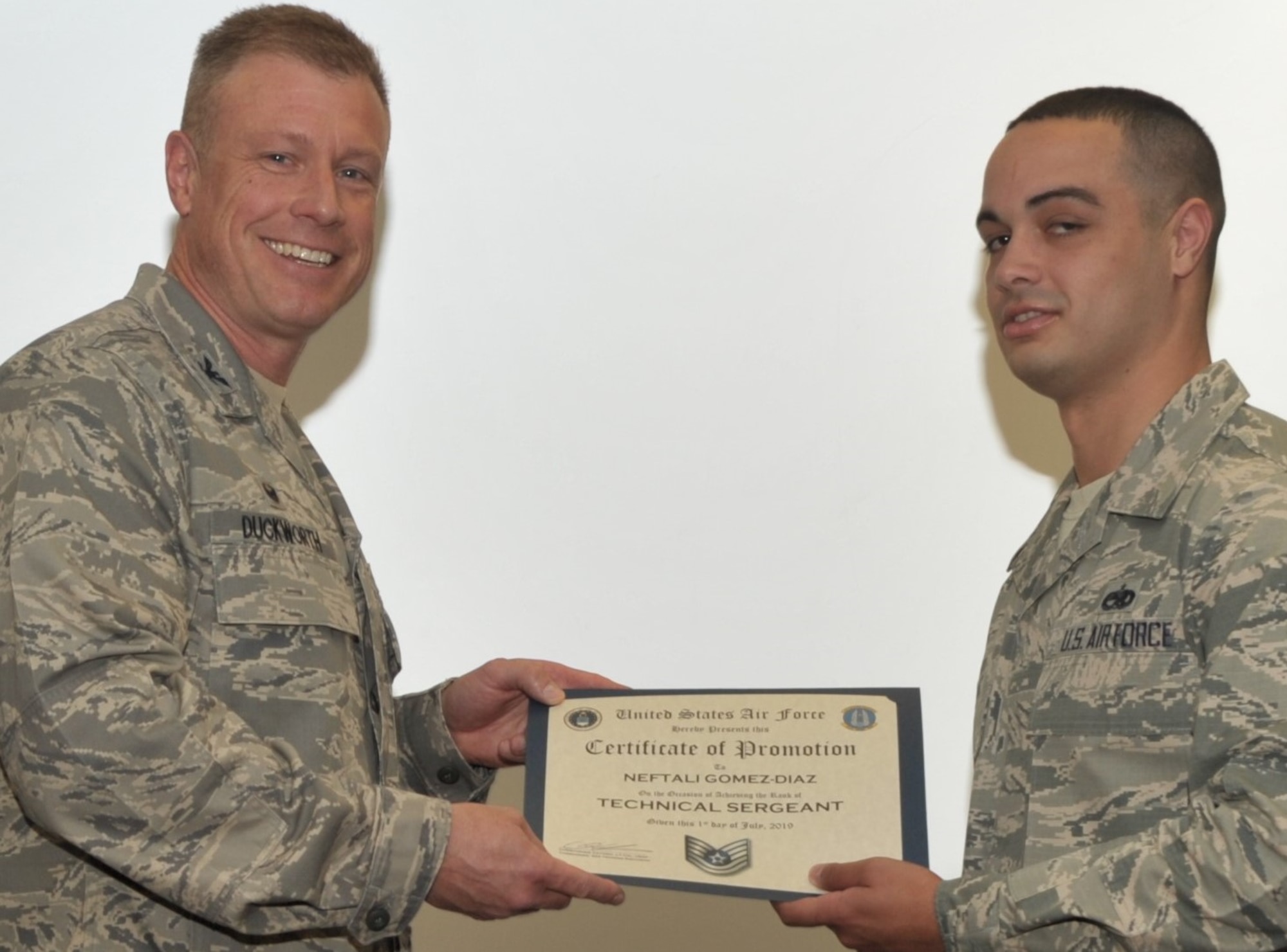 Tech. Sgt. Neftali Gomez-Diaz, Reserve military training instructor assigned to the 433rd Training Squadron, Joint Base San Antonio-Lackland, Texas, accepts the certificate of promotion to technical sergeant, presented by 340th Flying Training Group Commander Col. Allen Duckworth during the 433rd’s unit training assembly and enlisted summit held at JBSA-Lackland July 23-25. (U.S. Air Force photo by Debbie Gildea)