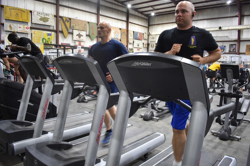 Army Staff Sergeants Robert W. Stephens and Raymond E. Stephens spend time together in the gym while deployed to Camp Arifjan, Kuwait, with the 77th Sustainment Brigade, July 30, 2019.