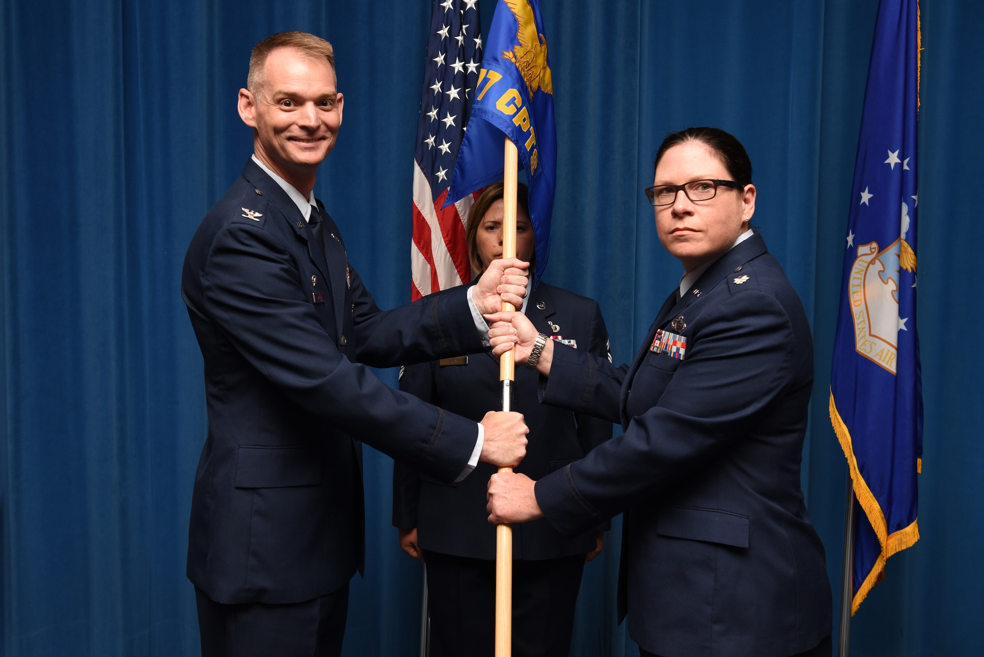 U.S. Air Force Lt. Col. Shay Edwards (right), accepts the guidon and command of the 377th Comptroller Squadron from Col. David Miller, 377th Air Base Wing commander, during a change of command ceremony at Kirtland Air Force Base, N.M., July 31, 2019. Edwards previously served as the U.S. Air Forces in Europe and Africa Budget and Operations Branch Chief. (U.S. Air Force photo by Senior Airman Eli Chevalier)