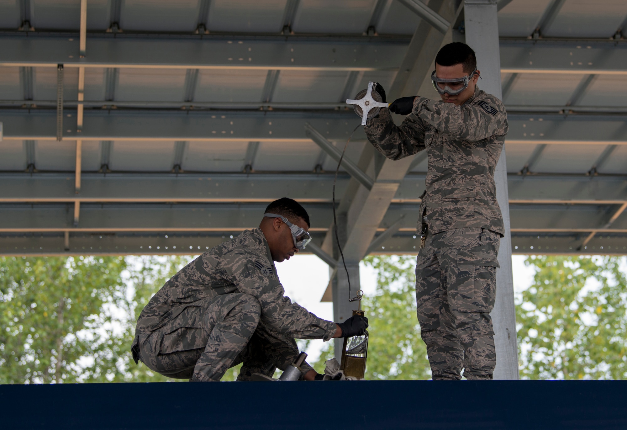 U.S. Air Force Senior Airman Jherron Parks-Harris, a 673d Logistics Readiness Squadron fuels laboratory technician, and U.S. Air Force Staff Sgt. Daniel Arteaga, a 673d LRS fuels laboratory noncommissioned officer in charge, pull an all-level sample from a tanker truck at a tank truck offload facility on Joint Base Elmendorf-Richardson, Alaska, July 25, 2019. The TTOF became fully operational December 2018, and provides a secondary means to receive JP-8 (Jet Propellant 8) in the event JBER’s fuel pipelines are out of service due to maintenance, damage or natural disaster.