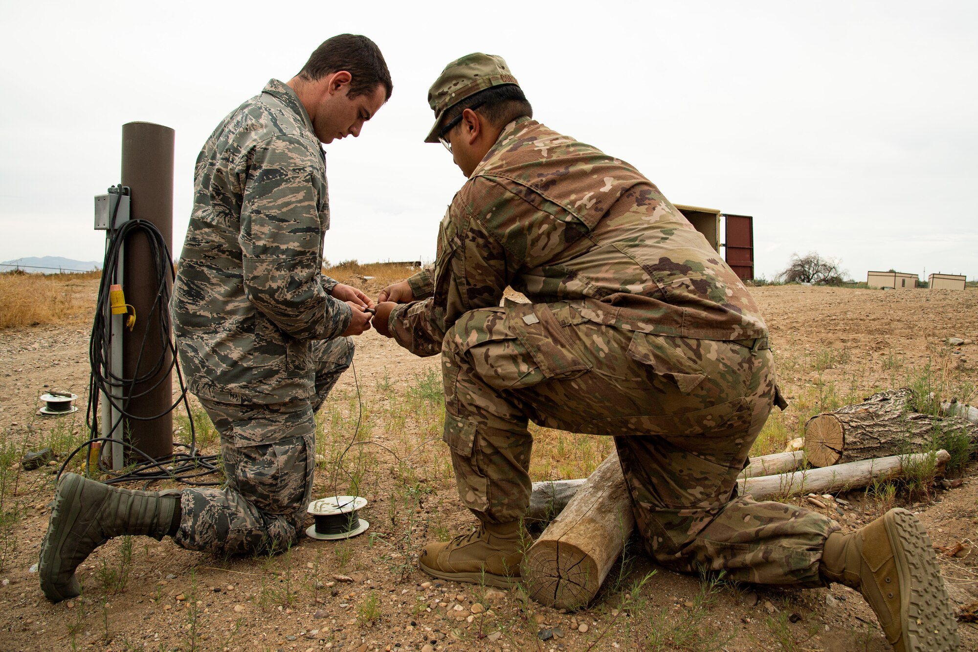 Air Force ROTC cadet Luke Carey, left, assisted by Staff Sgt. Guadalupe Corona, 775th Explosive Ordnance Disposal Flight, prepares to detonate an explosive charge at Hill Air Force Base, Utah, July 31, 2019. Over 80 cadets visited Hill as part of a professional development training program called Operation Air Force. The program gives cadets a greater understanding of the Air Force while introducing them to a variety of careers fields. (U.S. Air Force photo by R. Nial Bradshaw)