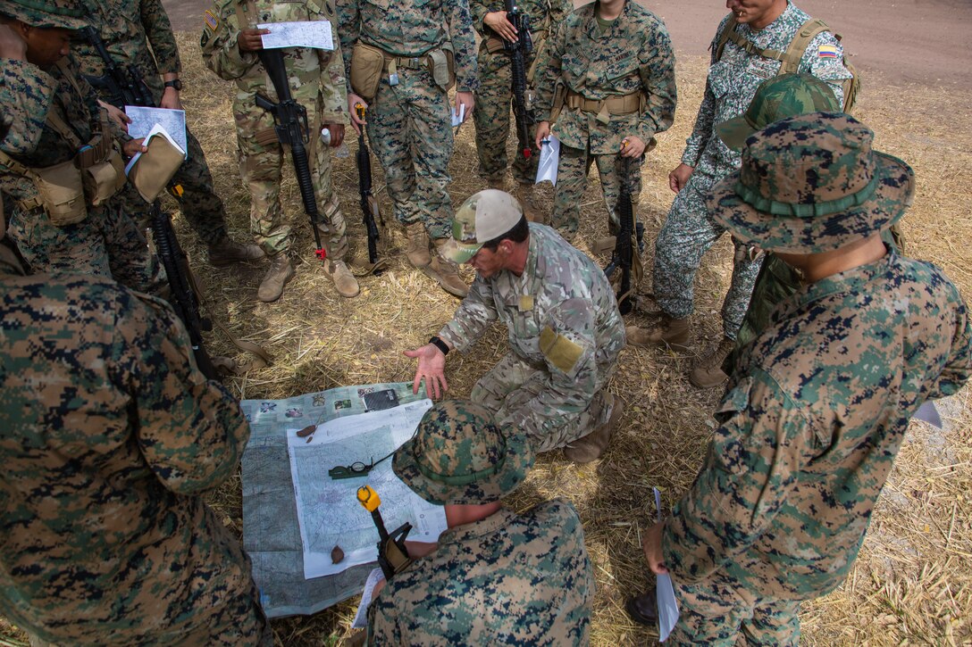 Military personnel train in the jungle.