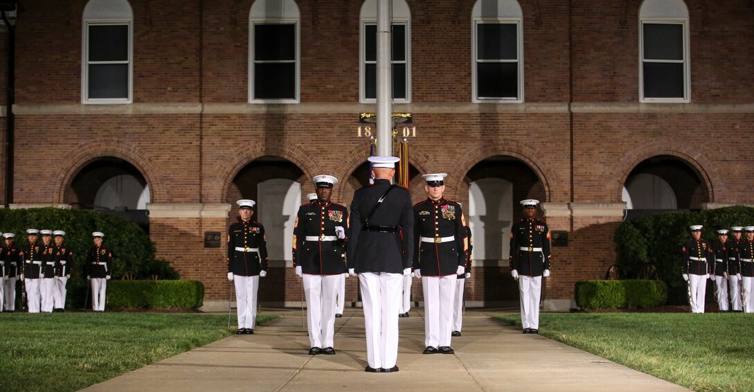 Commandant of the Marine Corps Gen. David H. Berger, center, 18th Sergeant Major of the Marine Corps Sergeant Maj. Ronald L. Green, center-left, and 19th Sergeant Major of the Marine Corps Sergeant Maj. Troy E. Black, center-right, execute a relief and appointment ceremony during the Staff Noncommissioned Officer Friday Evening Parade at Marine Barracks Washington D.C., July 26, 2019. The emblematic passing of the sword of office signifies the transfer of the senior enlisted leader of Marines and advisor to the commandant from Sgt. Maj. Green to Sgt. Maj. Black. (U.S. Marine Corps photo by Pfc. Allen Sanders)