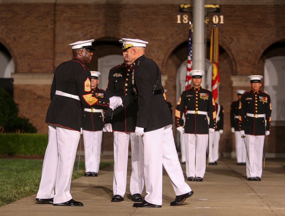 Commandant of the Marine Corps Gen. David H. Berger and 18th Sergeant Major of the Marine Corps Sgt. Maj. Ronald L. Green shake hands at the conclusion of a relief and appointment ceremony at Marine Barracks Washington, D.C., July 26, 2019. The emblematic passing of the sword of office signifies the transfer of the senior enlisted leader of Marines and advisor to the commandant from Sgt. Maj. Green to 19th Sergeant Major of the Marine Corps Sgt. Maj. Troy E. Black. (U.S. Marine Corps photo by Pfc. Allen Sanders)