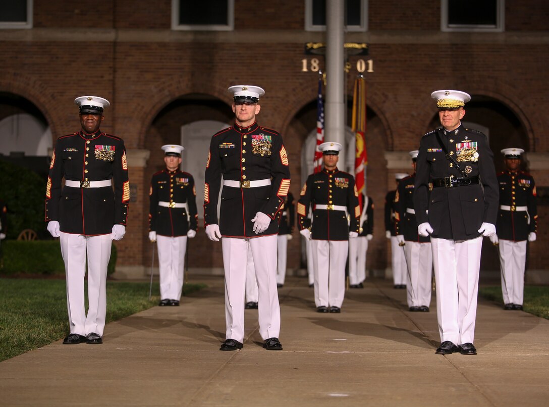 Sergeant Maj. Ronald L. Green, 18th Sergeant Major the Marine Corps, left, Sergeant Maj. Troy E. Black, 19th Sergeant Major of the Marine Corps, middle, and Commandant of the Marine Corps Gen. David H. Berger, right, stand in the reviewing area at the conclusion of a relief and appointment ceremony at Marine Barracks Washington, D.C., July 26, 2019. The emblematic passing of the sword of office signifies the transfer of the senior enlisted leader of Marines and advisor to the commandant from 18th Sergeant Major of the Marine Corps Sgt. Maj. Ronald L. Green to Sgt. Maj. Black. (U.S. Marine Corps photo by Pfc. Allen Sanders/Released)